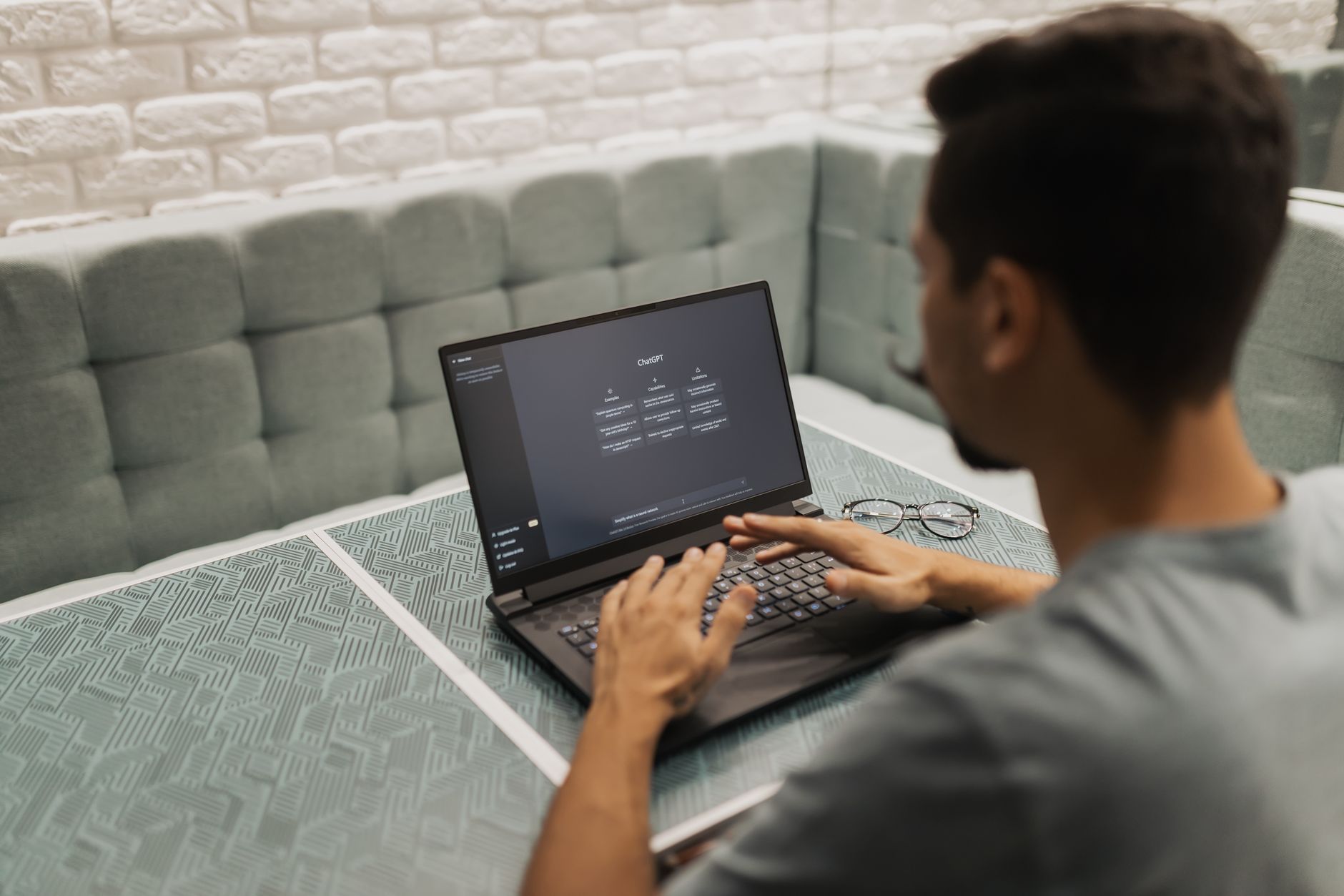 a laptop showing a no-code automation workflow with nodes and a draft content output