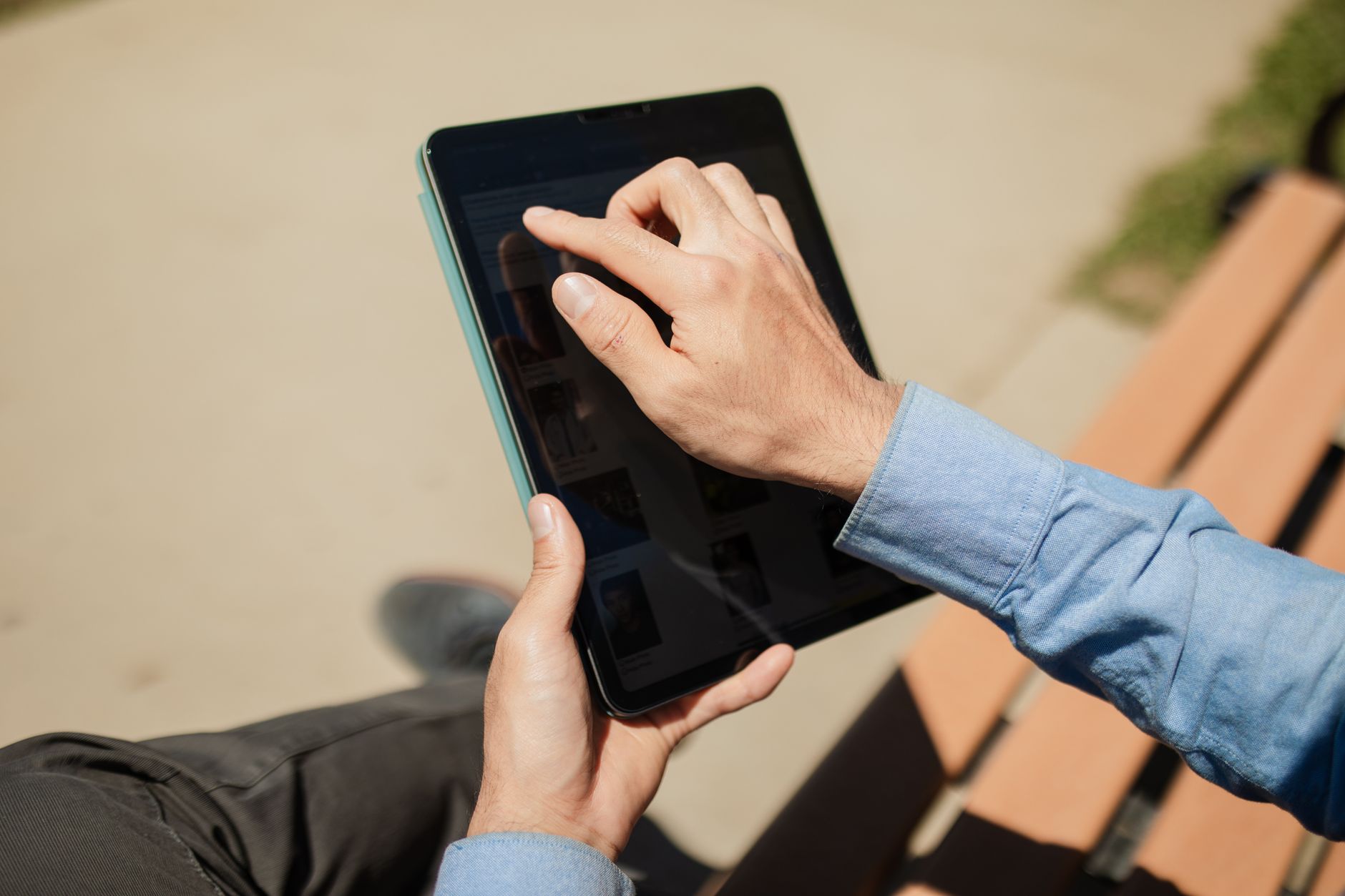 person reviewing social media posts on a tablet with a cup of coffee nearby