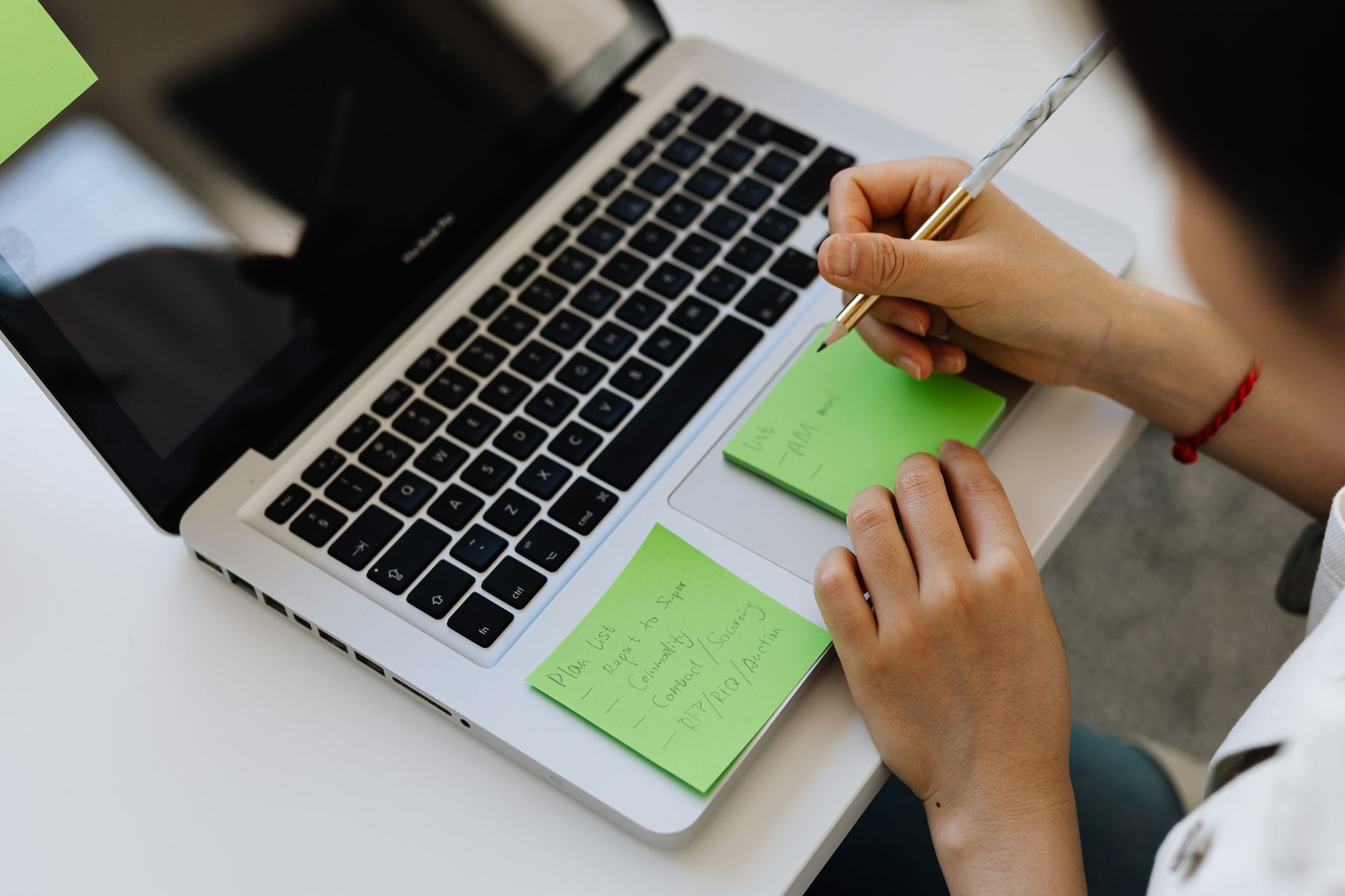 Freelancer scheduling social media posts on a laptop at a bright desk