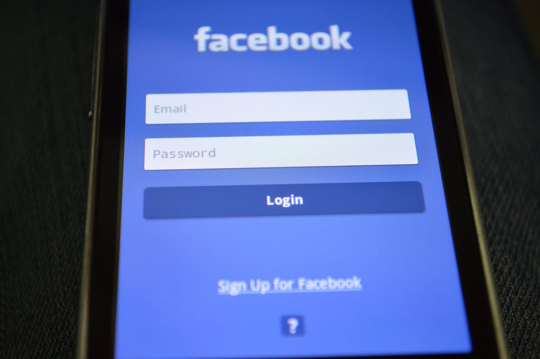 A smartphone showing a two-factor authentication prompt next to a laptop