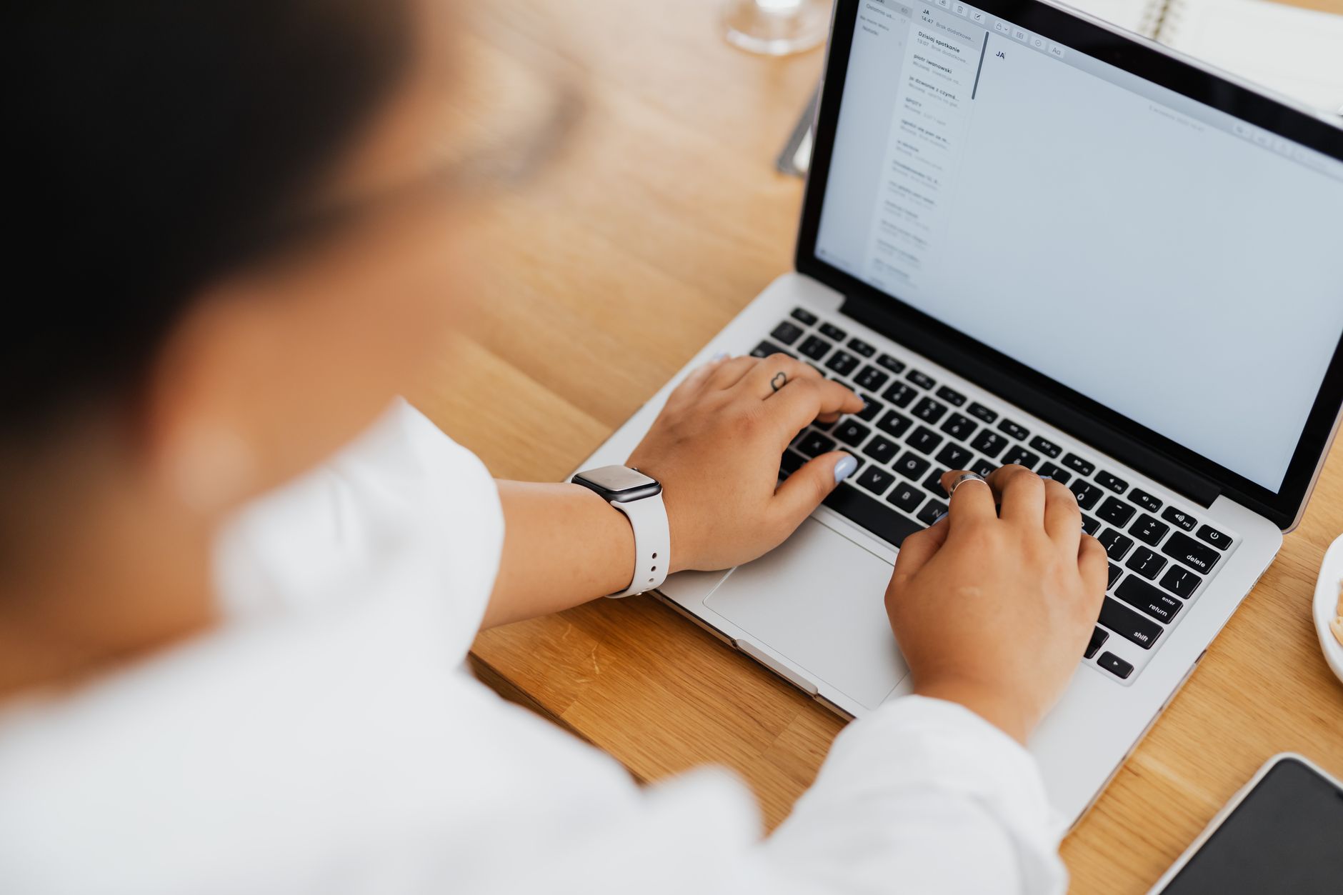 freelancer emailing a client invoice from a laptop in a home office