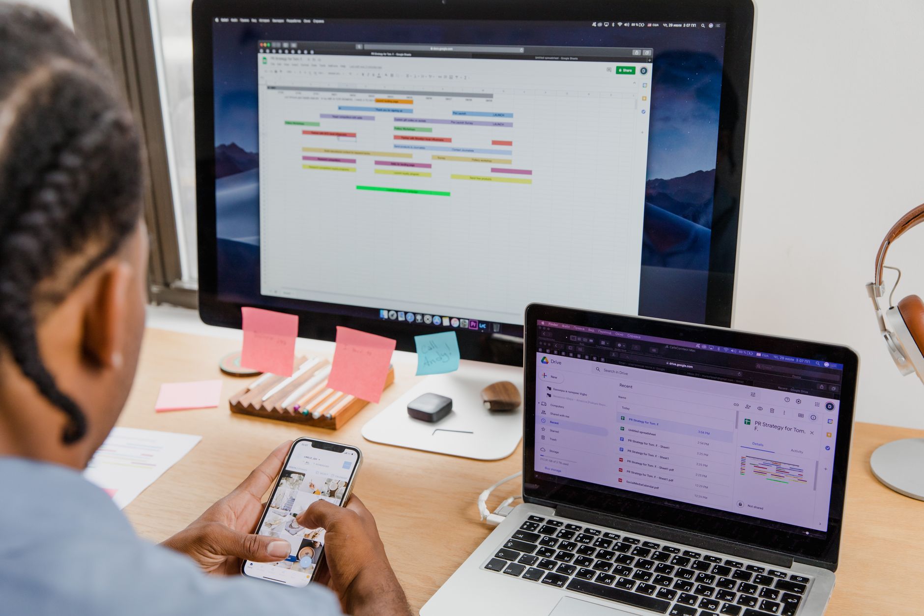 Person configuring app integrations on a laptop with sticky notes nearby