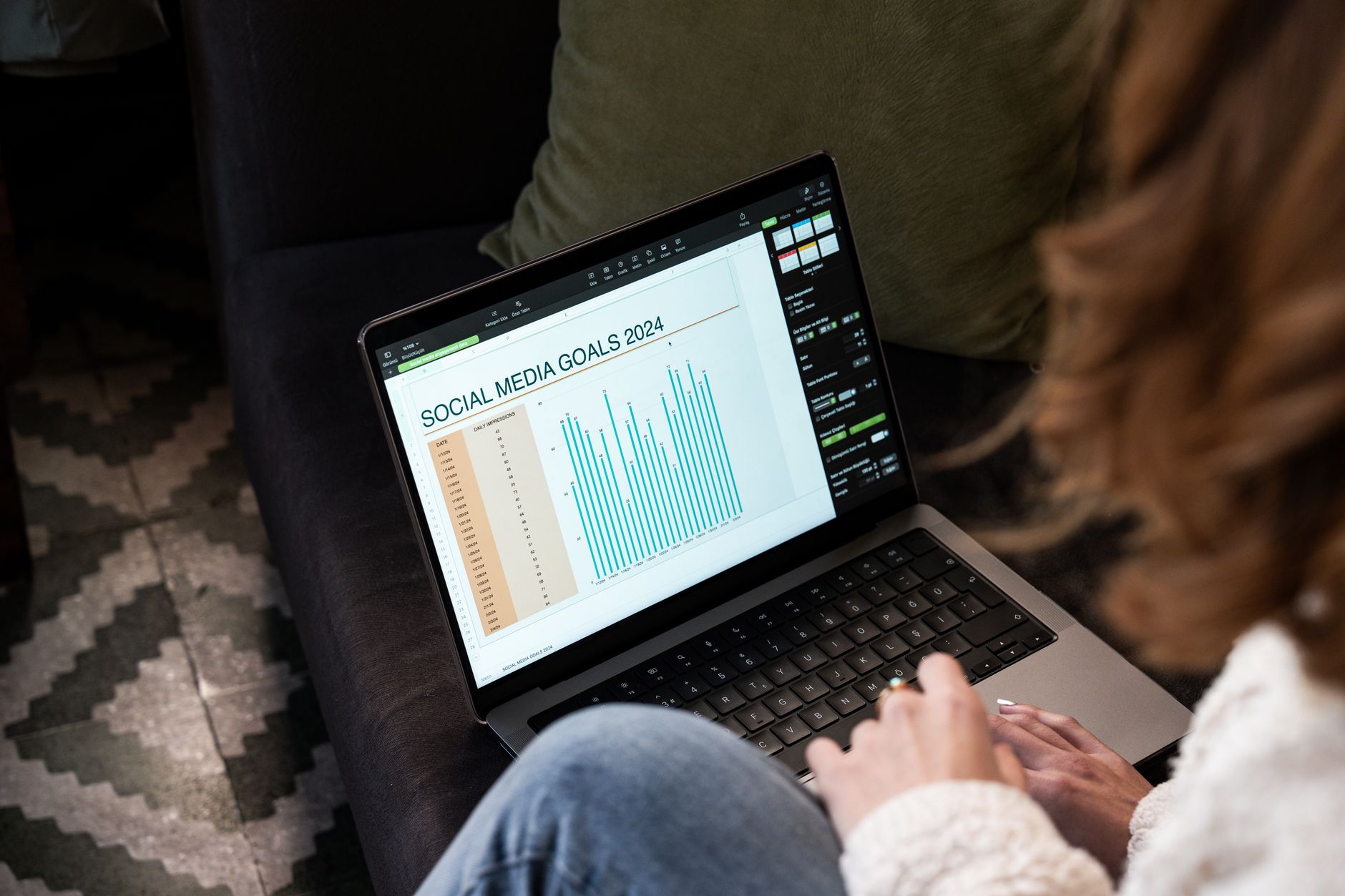 Freelancer planning social media posts with phone and laptop side by side